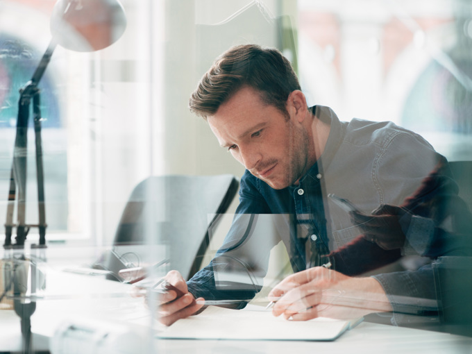 Businessman Using Laptop At Work